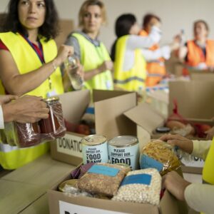 Volunteers collecting food for donation in boxes