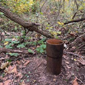 Abandoned well pipe in the woods